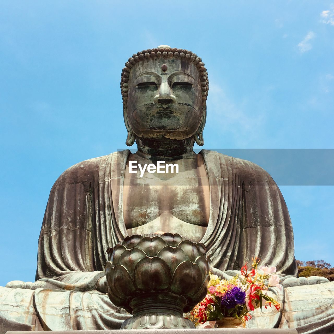 Statue of buddha against blue sky