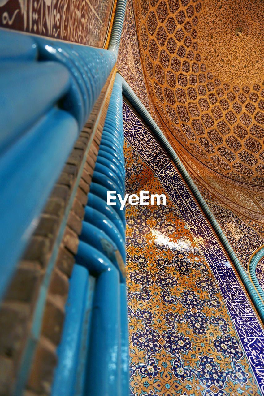 Low angle view of blue column and ceiling in mosque