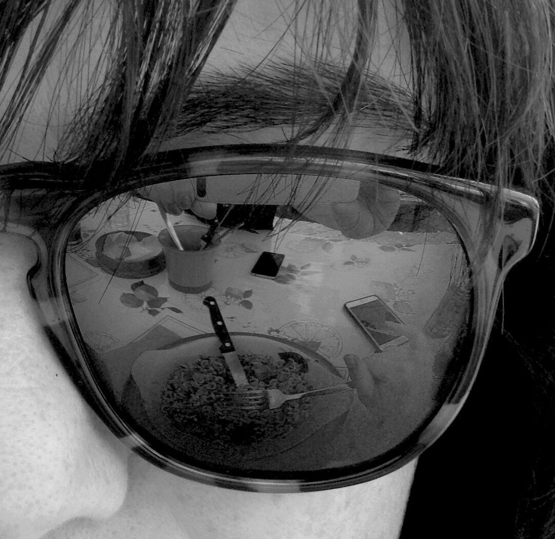 Reflection of food plate on sunglasses