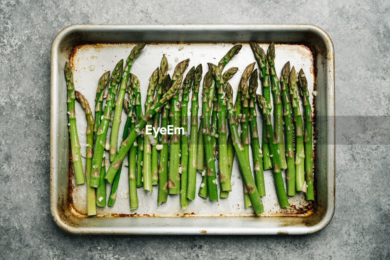 Oiled asparagus on a baking sheet