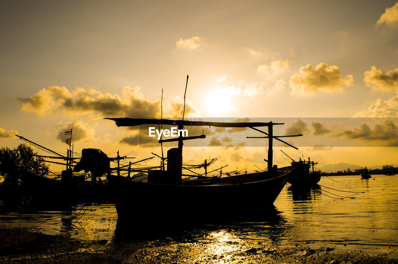 Silhouette boat in sea against sky during sunset