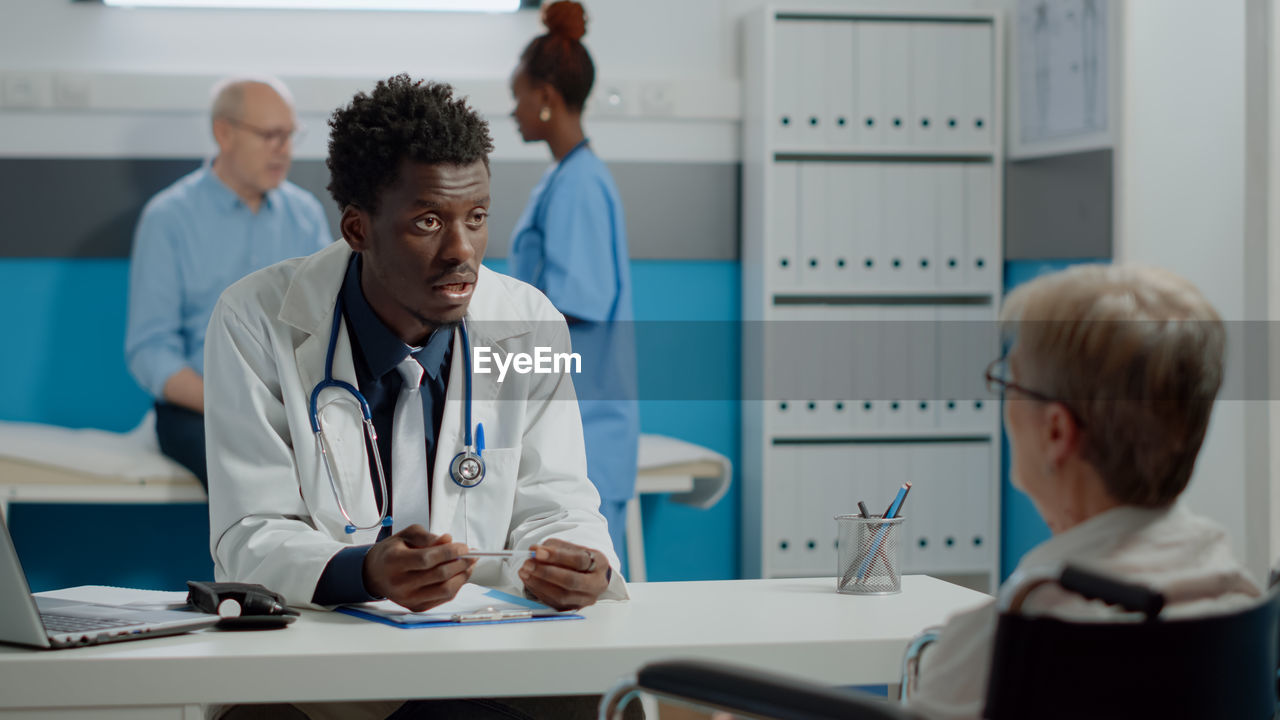 Doctor having discussion with patient in clinic