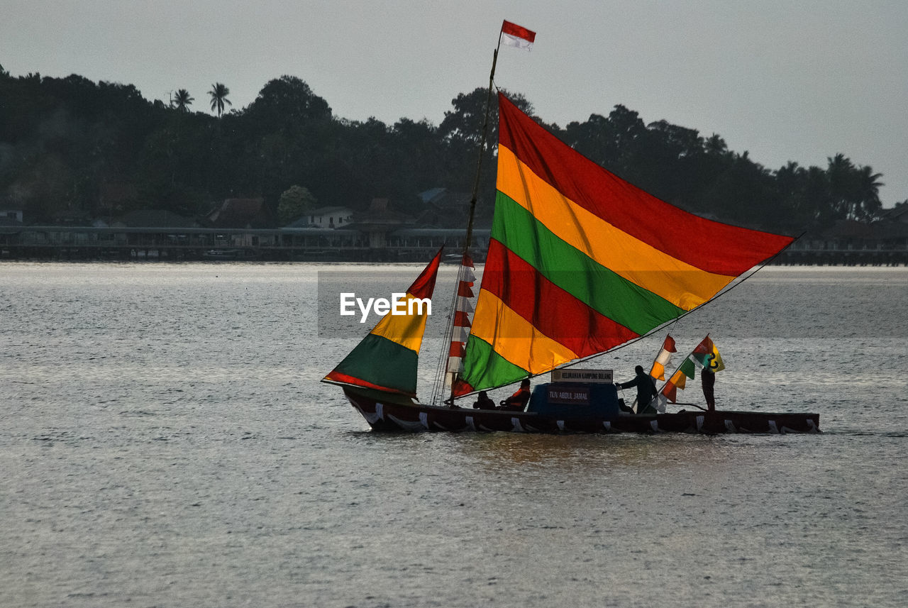 FLAG ON BOAT AGAINST SKY