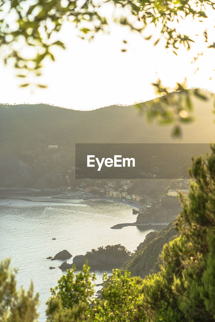 High angle of houses located on coast of sea near mountain slope at sunset on resort in monterosso al mare, italy