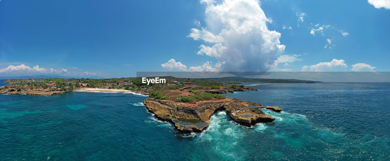 PANORAMIC SHOT OF SEA AND ROCKS AGAINST SKY