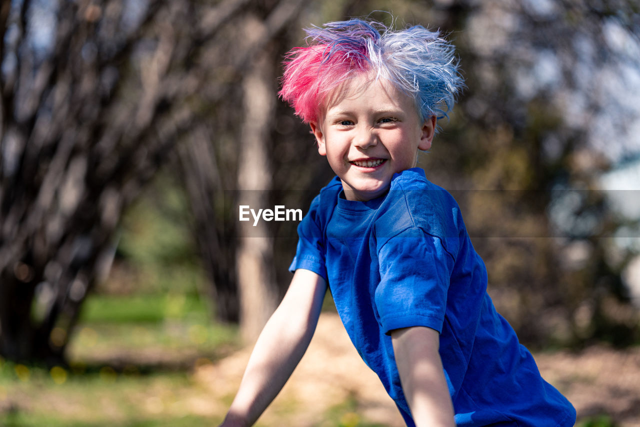 Young boy jumping and playing cheerfully