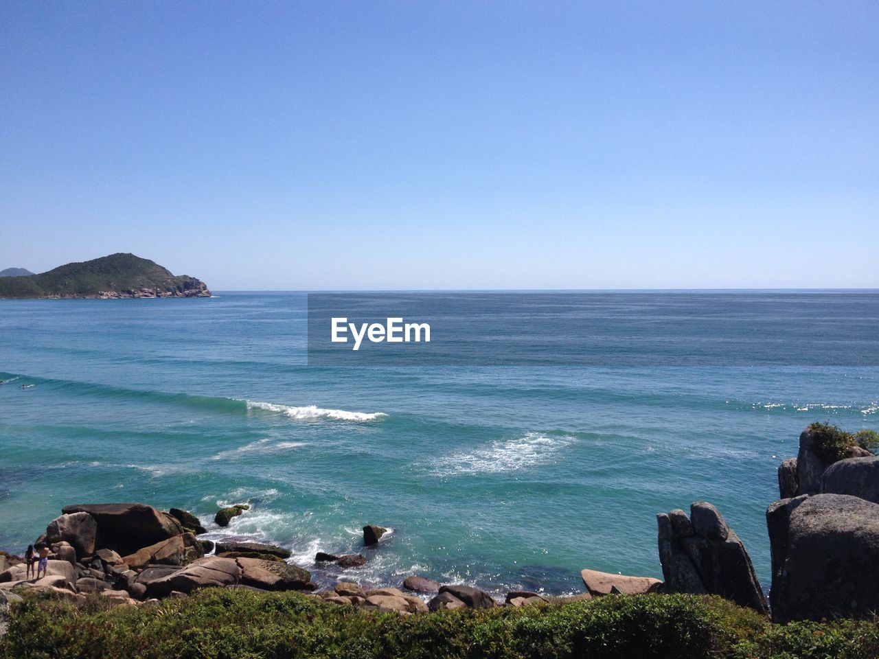 Scenic view of sea against clear blue sky