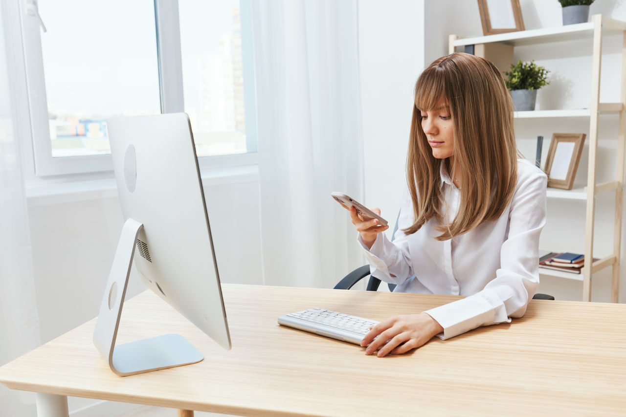 portrait of young woman using laptop on table