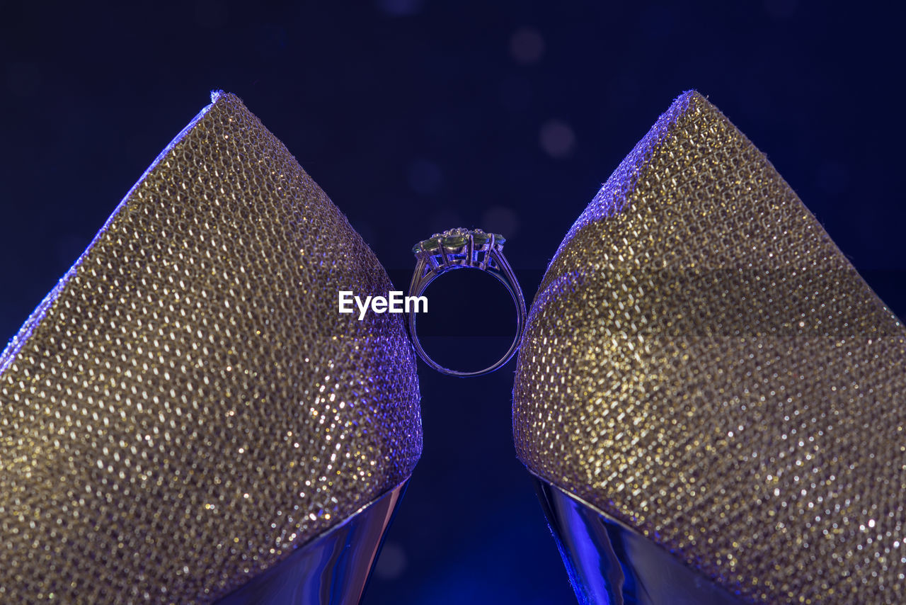 LOW ANGLE VIEW OF ILLUMINATED LIGHTING EQUIPMENT AGAINST BLUE SKY