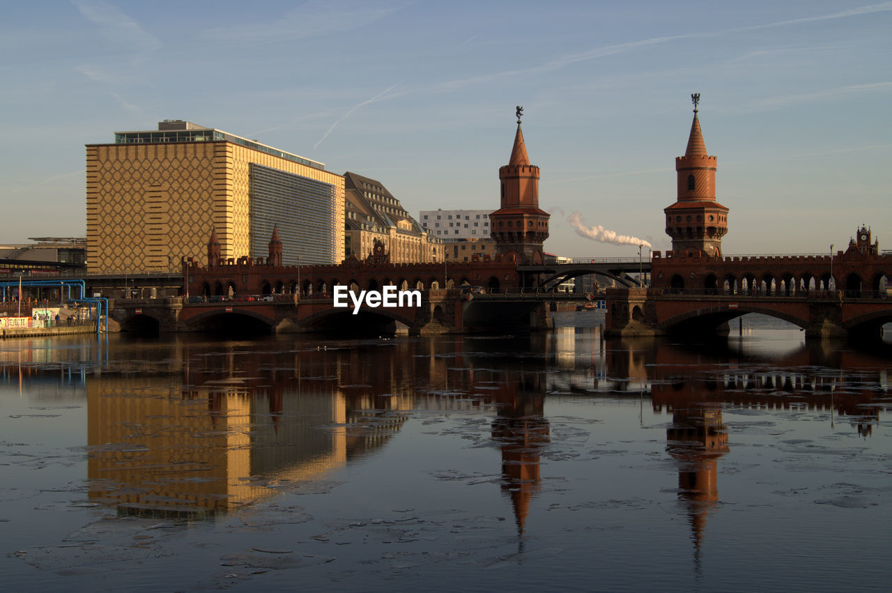 Bridge over river with buildings in background