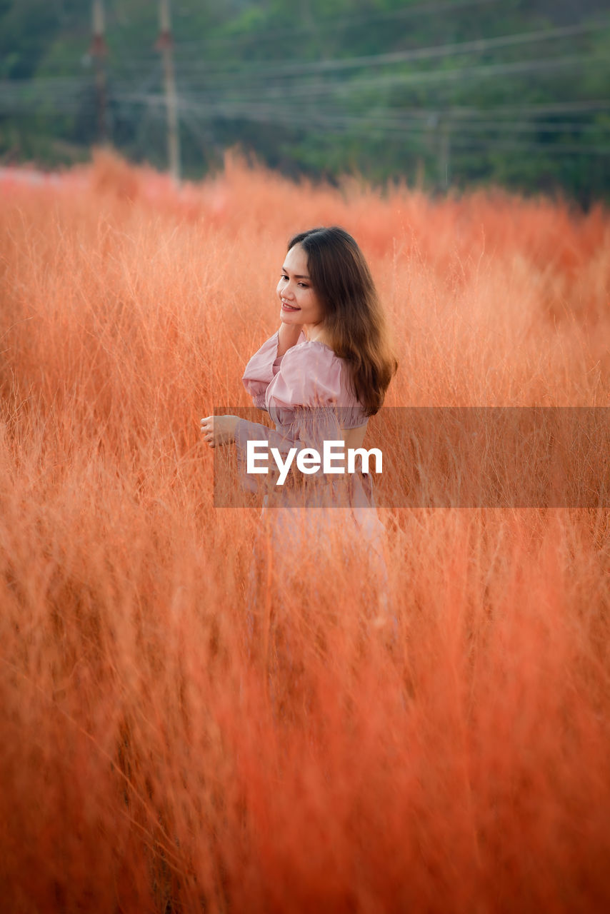 one person, women, grass, morning, nature, plant, land, adult, field, landscape, long hair, hairstyle, environment, sunlight, child, tranquility, human face, autumn, young adult, grassland, contemplation, rural scene, childhood, relaxation, prairie, outdoors, summer, lifestyles, side view, leisure activity, female, beauty in nature, selective focus, happiness, emotion, human eye, romance, meadow, smiling, day, brown hair, clothing, portrait, red, person, looking, enjoyment, human hair, waist up, tranquil scene, eyes closed, plain