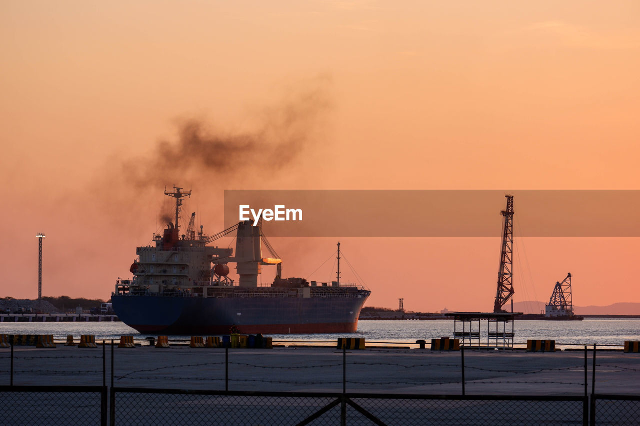 SHIP AT HARBOR AGAINST SKY