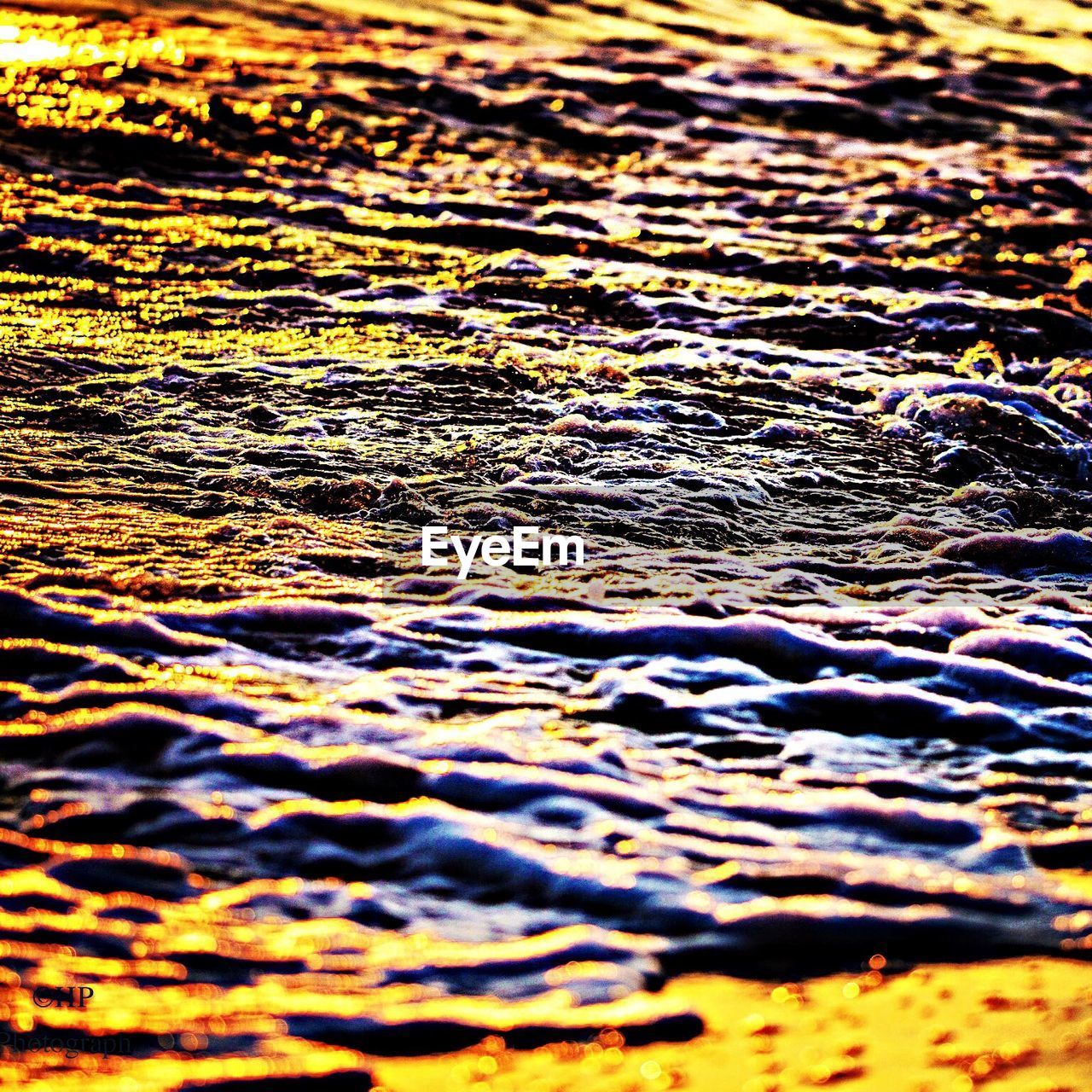 Close-up of wave at sunset