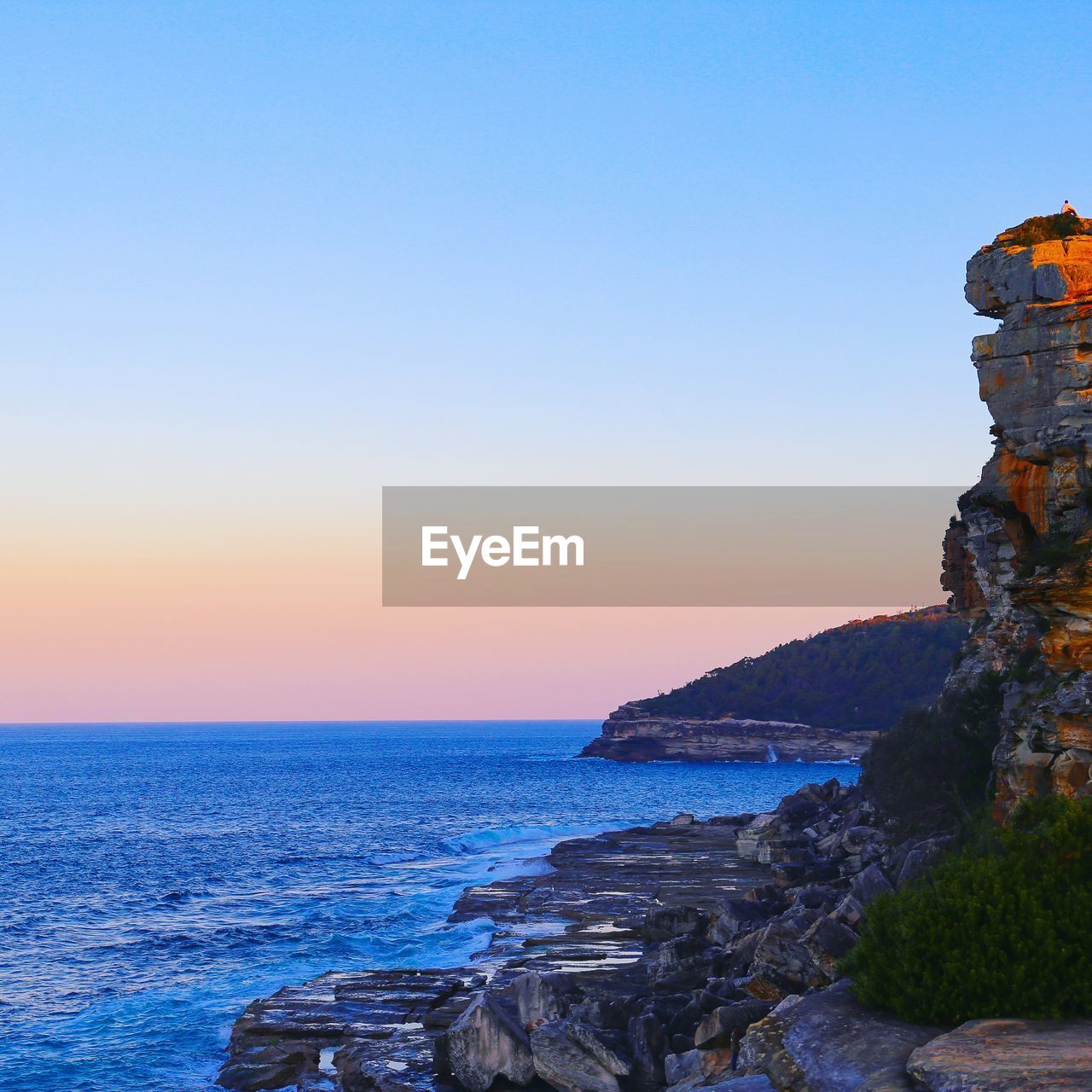 Scenic view of sea against clear sky during sunset