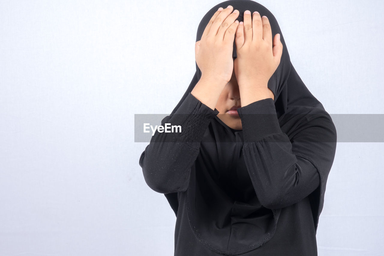 Girl wearing hijab over white background