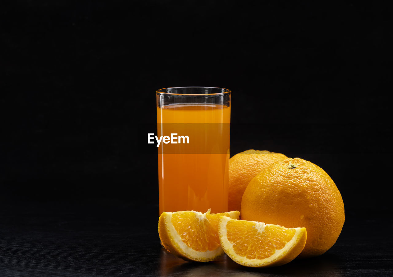 Close-up of orange juice against black background