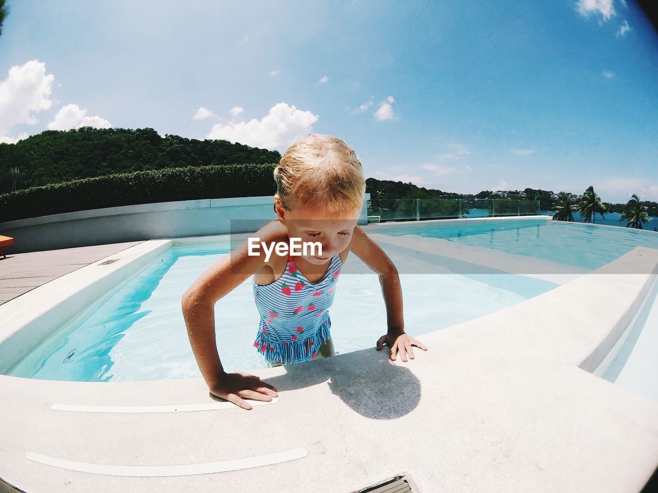 Portrait of boy in swimming pool against sky