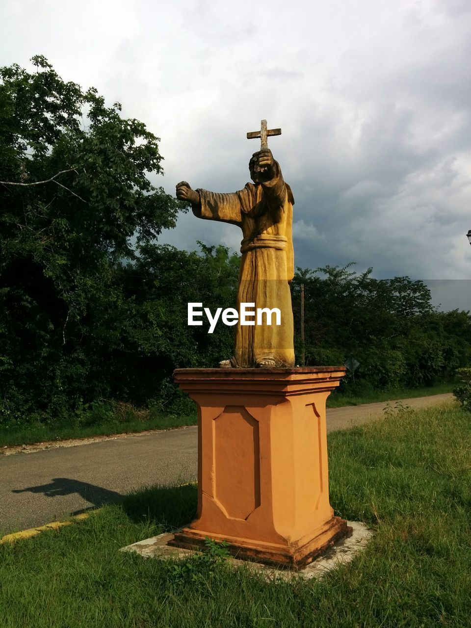 STATUE IN FRONT OF TREE