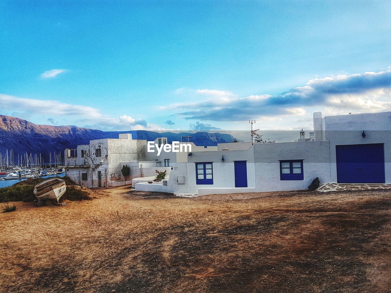 HOUSES ON SHORE AGAINST SKY