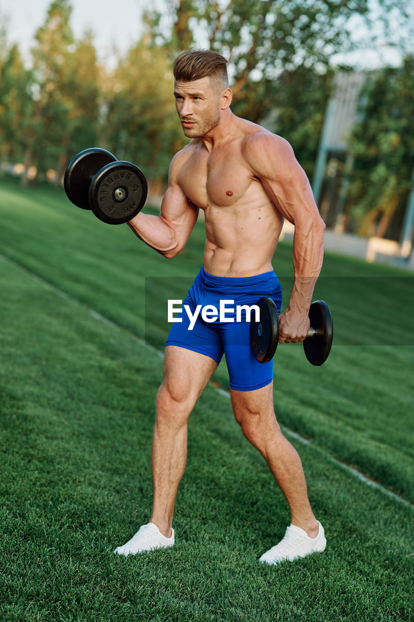 low section of man exercising on field