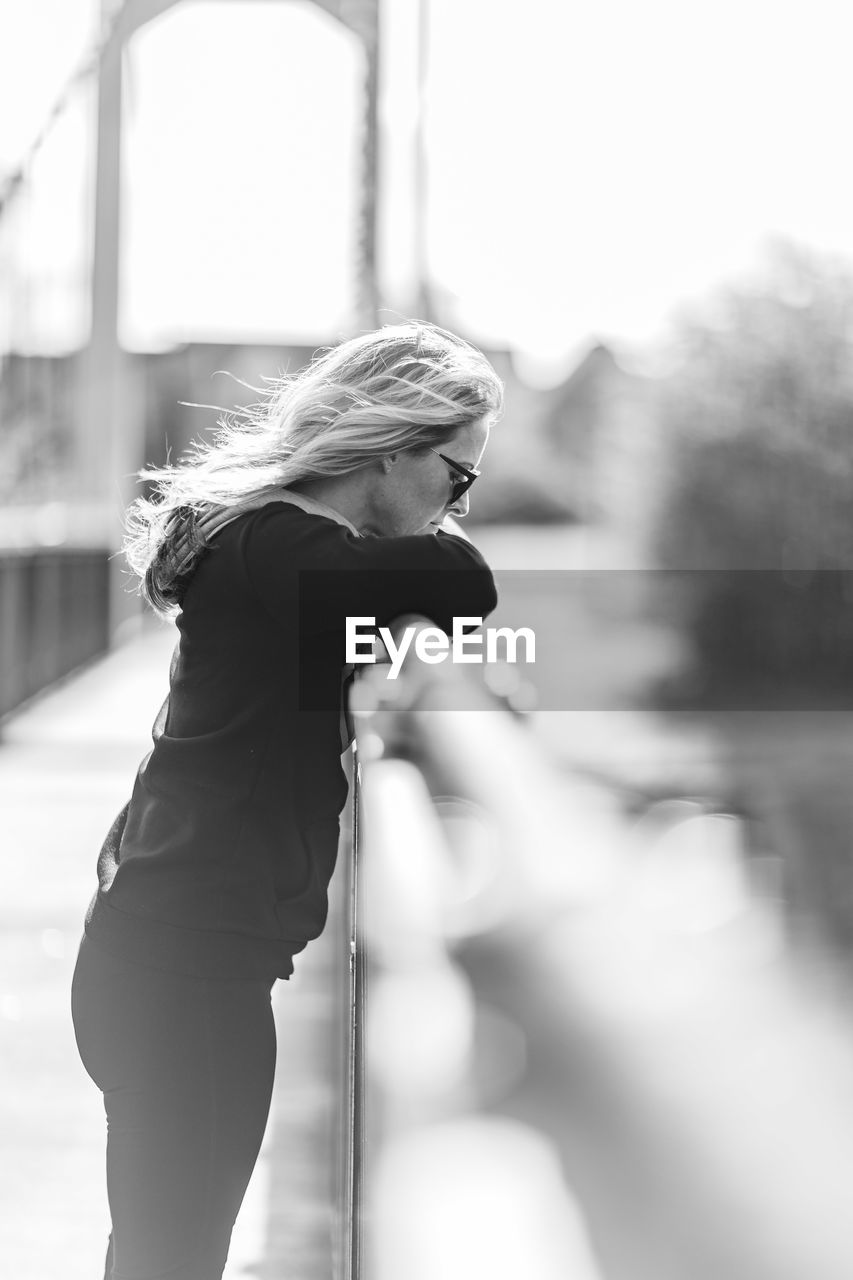 Mature woman standing on bridge