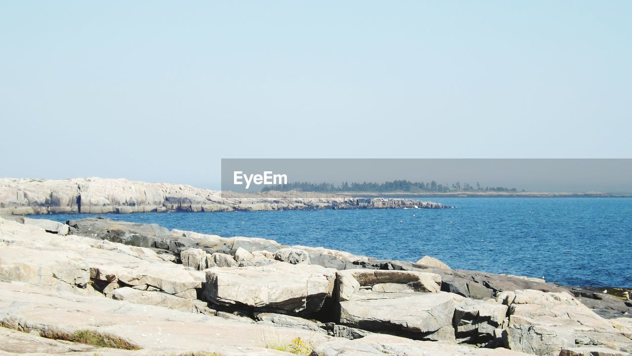 Rocks at sea against sky