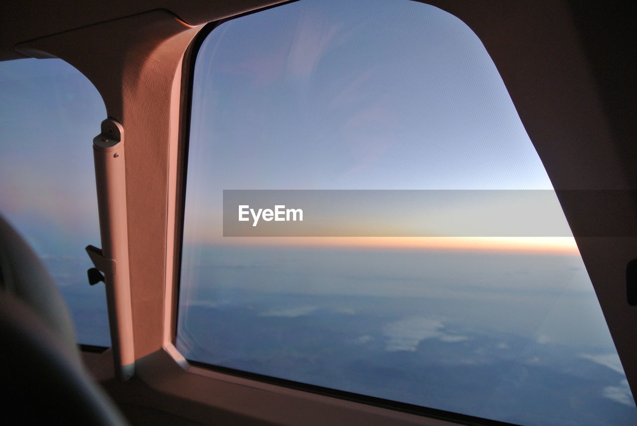 Close-up of airplane interior against sky during sunset