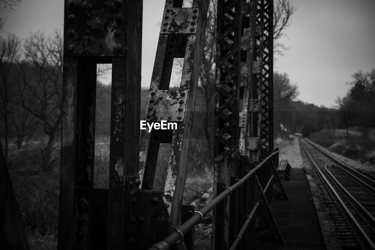 Railroad tracks by trees against sky