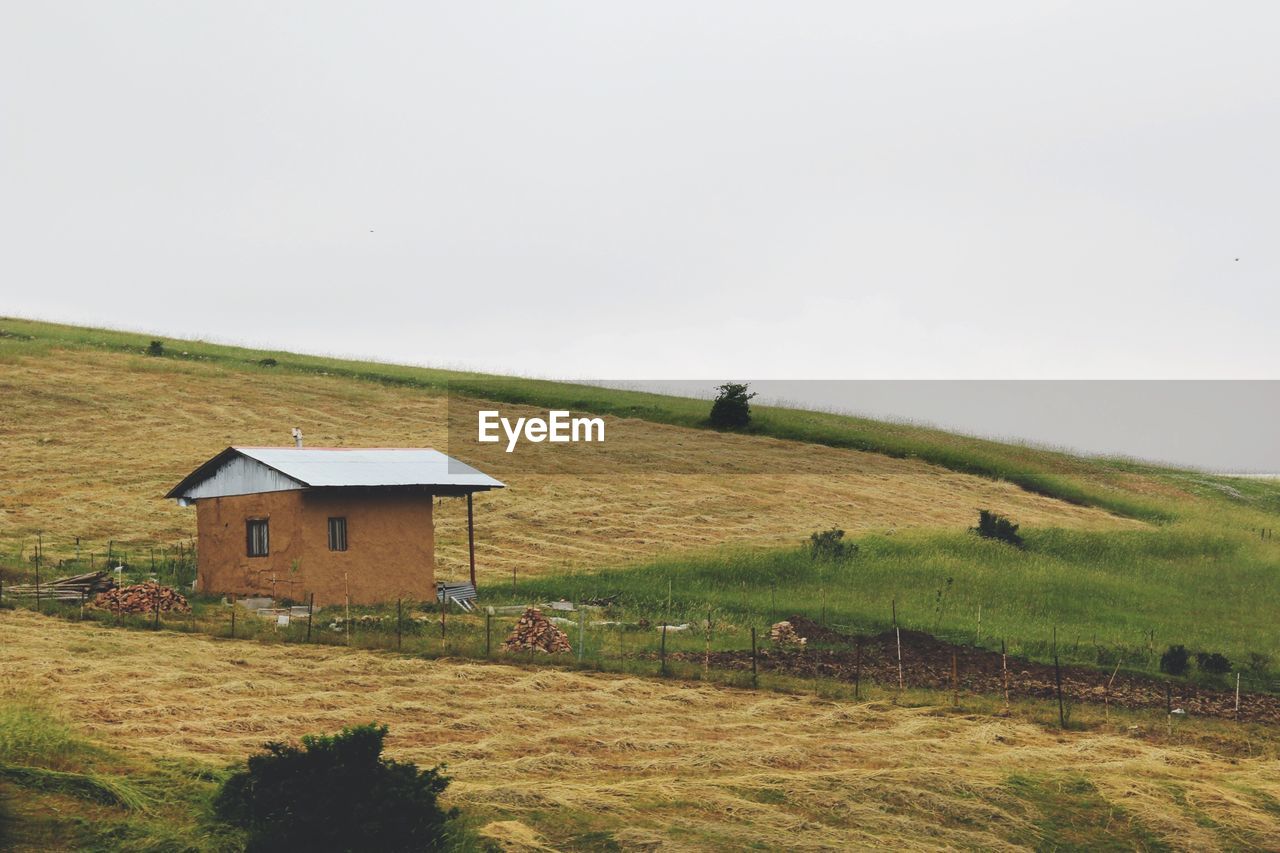 House on field by farm
