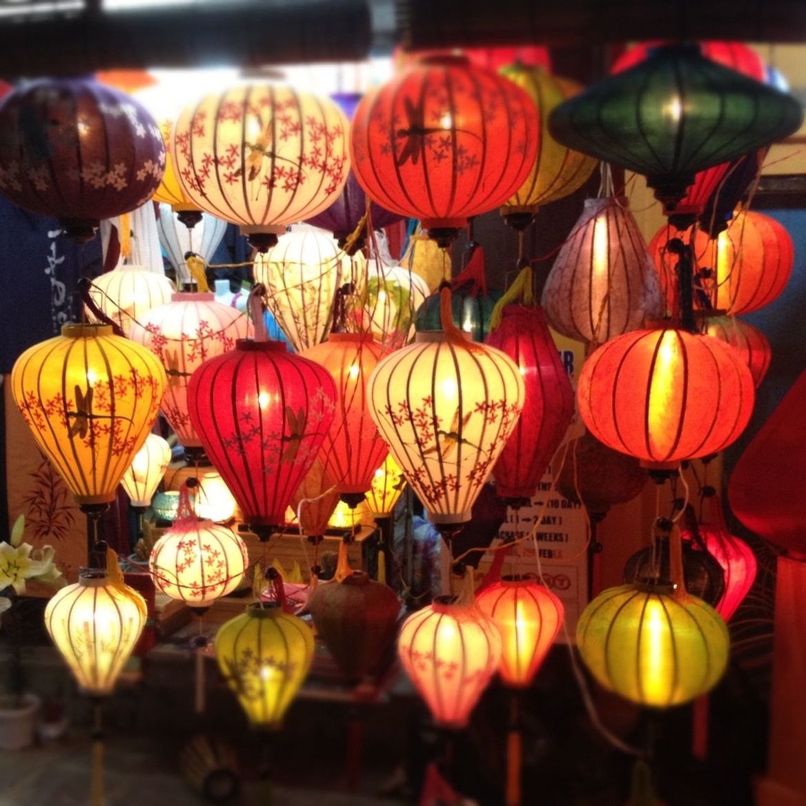 MULTI COLORED LANTERNS HANGING IN MARKET