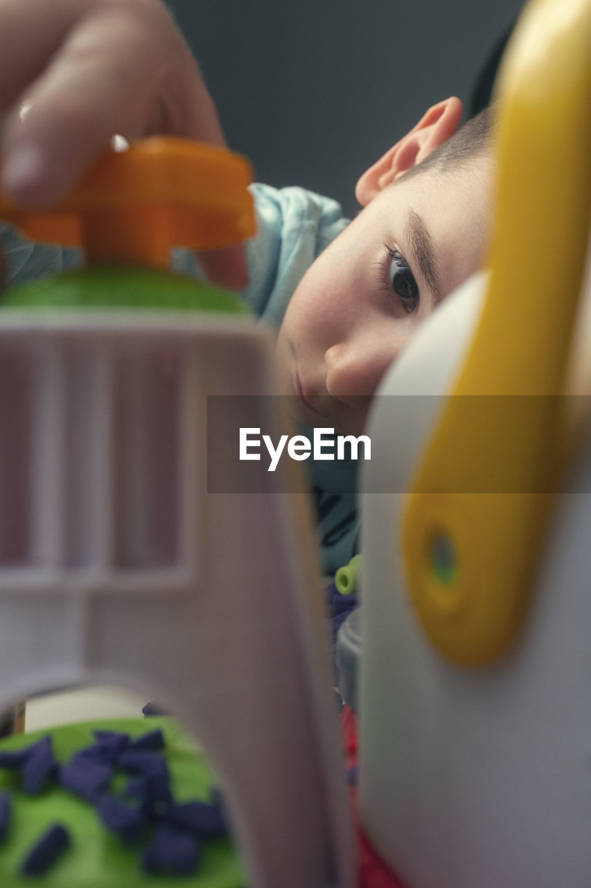 Boy playing with toy at home