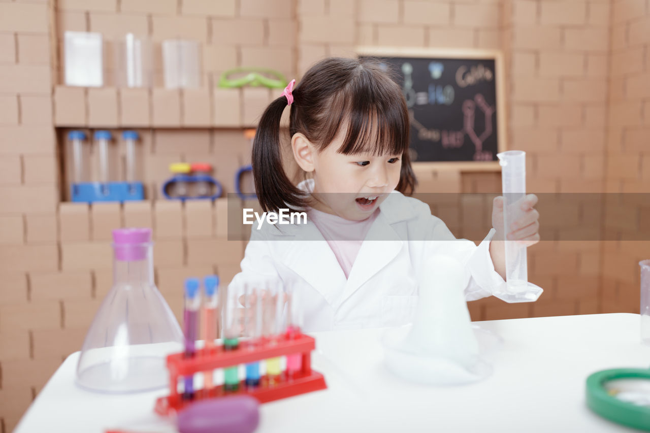 Young girl play science experiments for homeschooling