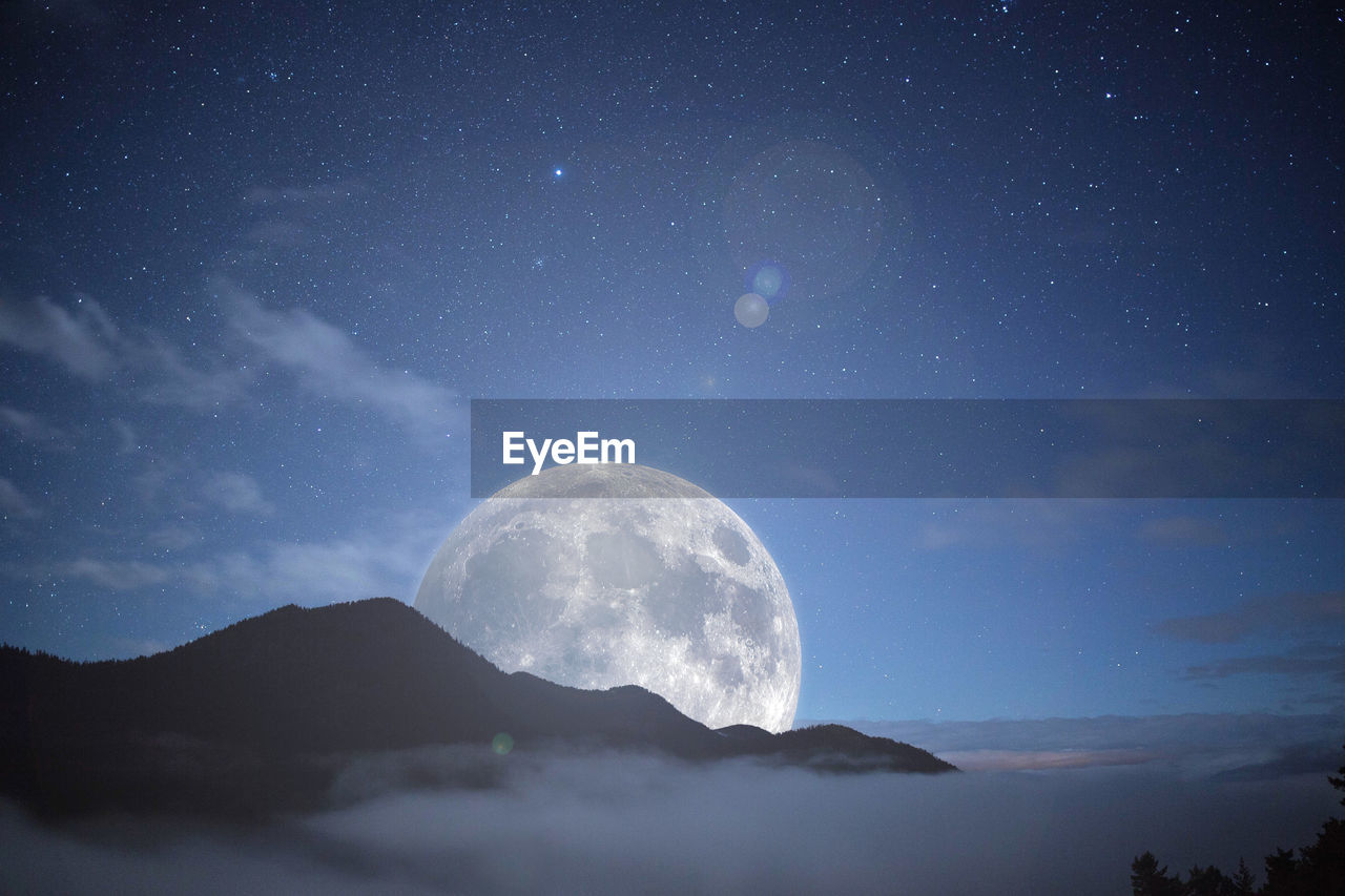 Low angle view of moon against sky at night