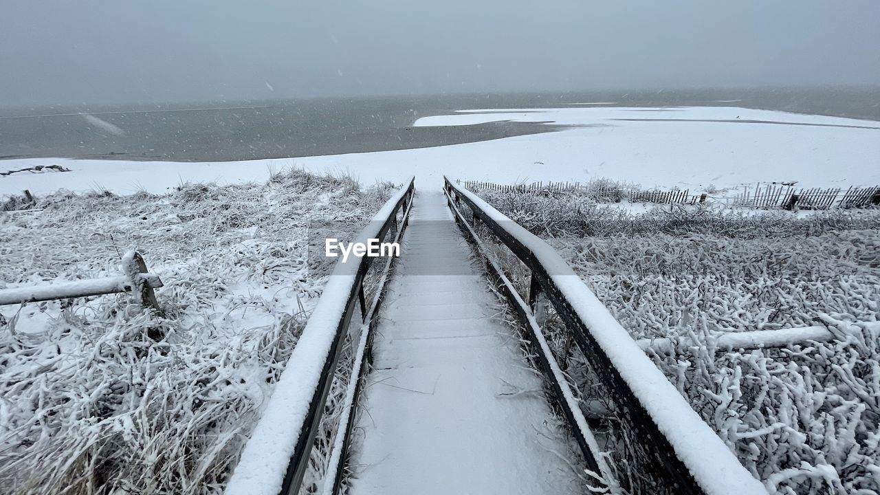 SNOW COVERED LAND ON FIELD