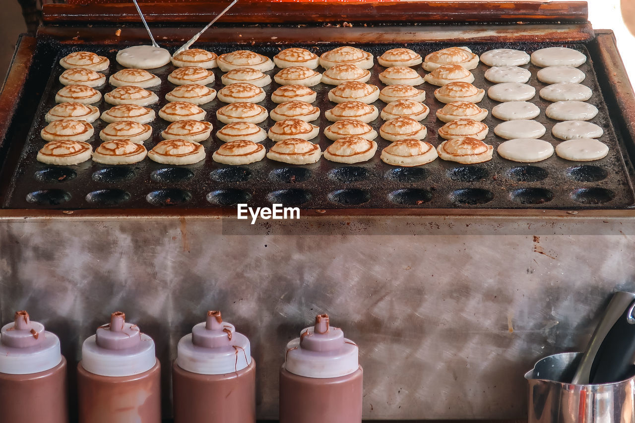 food and drink, food, no people, in a row, large group of objects, indoors, container, arrangement, dessert, business, freshness, order, still life, side by side, baked, high angle view, abundance