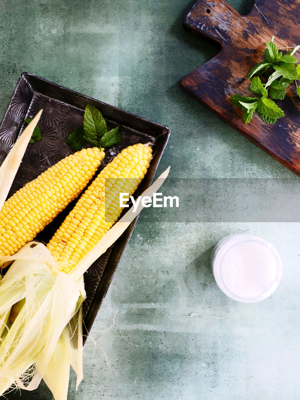 food, food and drink, vegetable, sweet corn, healthy eating, freshness, wellbeing, dish, high angle view, corn, produce, indoors, no people, yellow, raw food, cuisine, still life, organic, table, wood, nature, plant, studio shot, corn kernels, ingredient