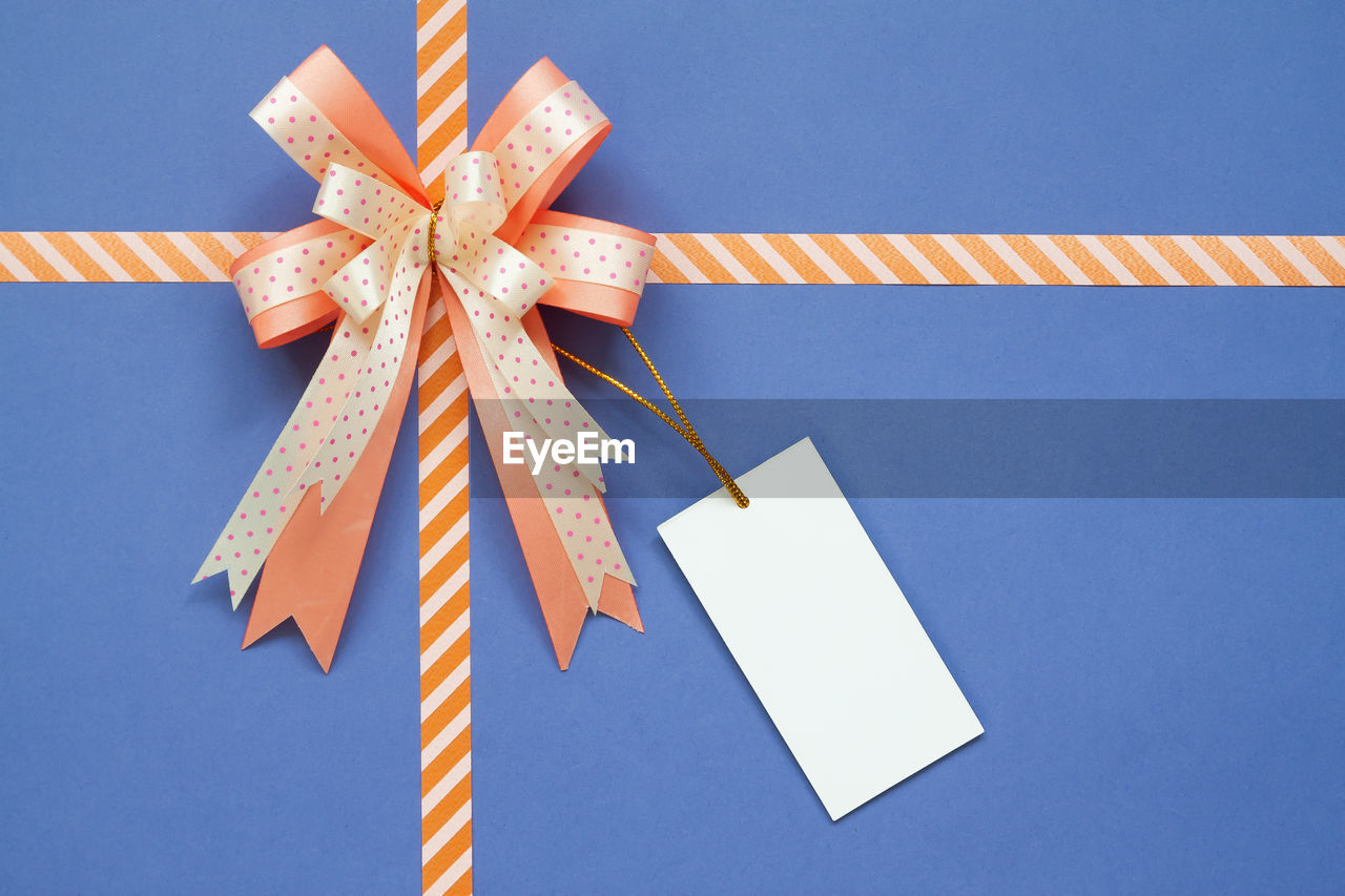 High angle view of ribbon tied on gift box