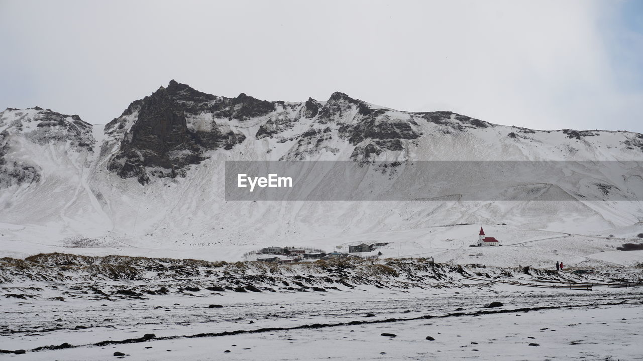 Scenic view of snow covered mountains against sky