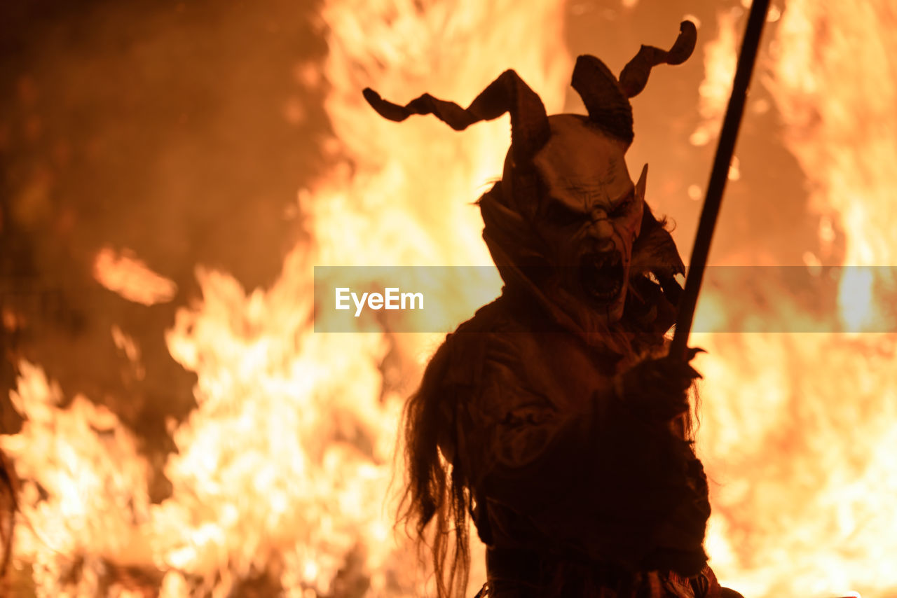 Man wearing spooky costume during halloween at night