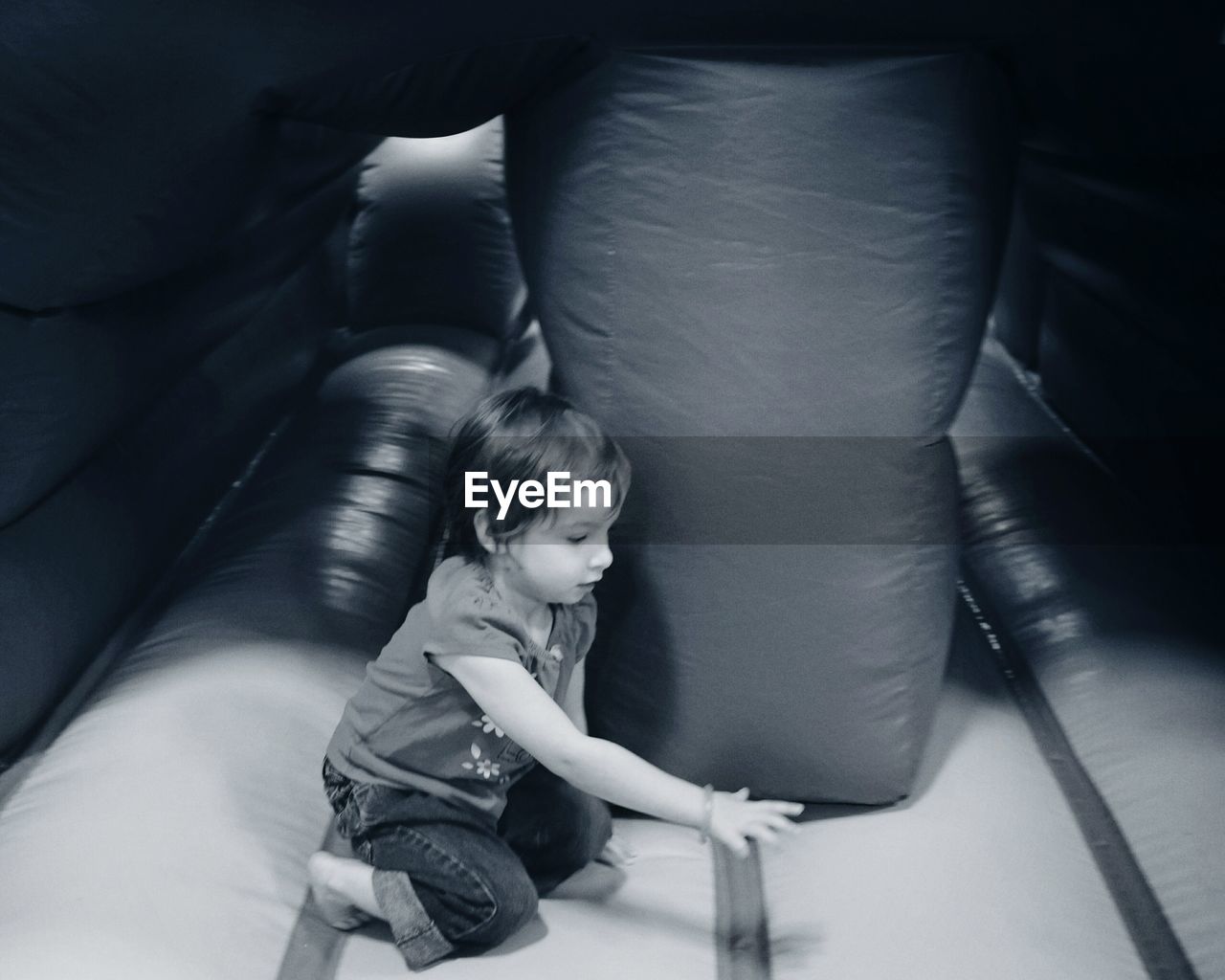 Side view of girl plying in bouncy castle