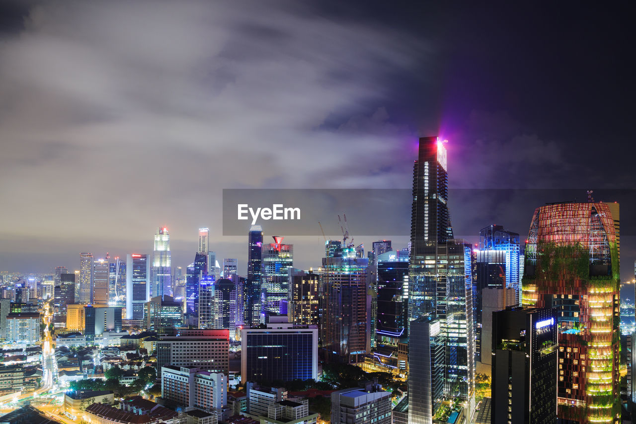 ILLUMINATED BUILDINGS IN CITY AGAINST SKY