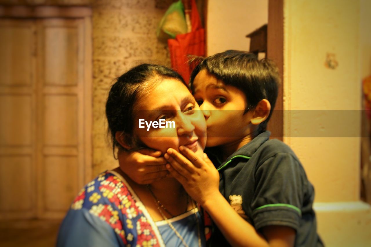 PORTRAIT OF MOTHER AND BOY IN MIRROR