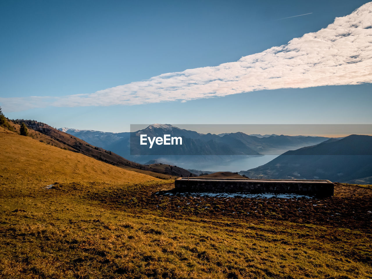 Scenic view of snowcapped mountains against blue sky