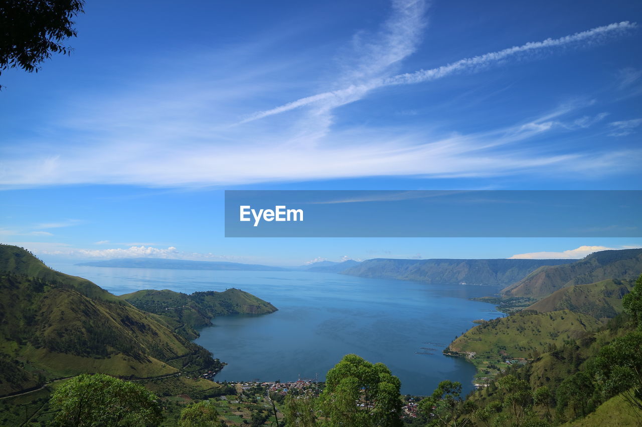 Scenic view of mountains against blue sky