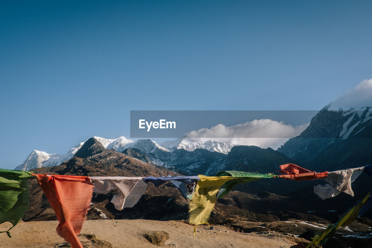 Scenic view of mountains against blue sky