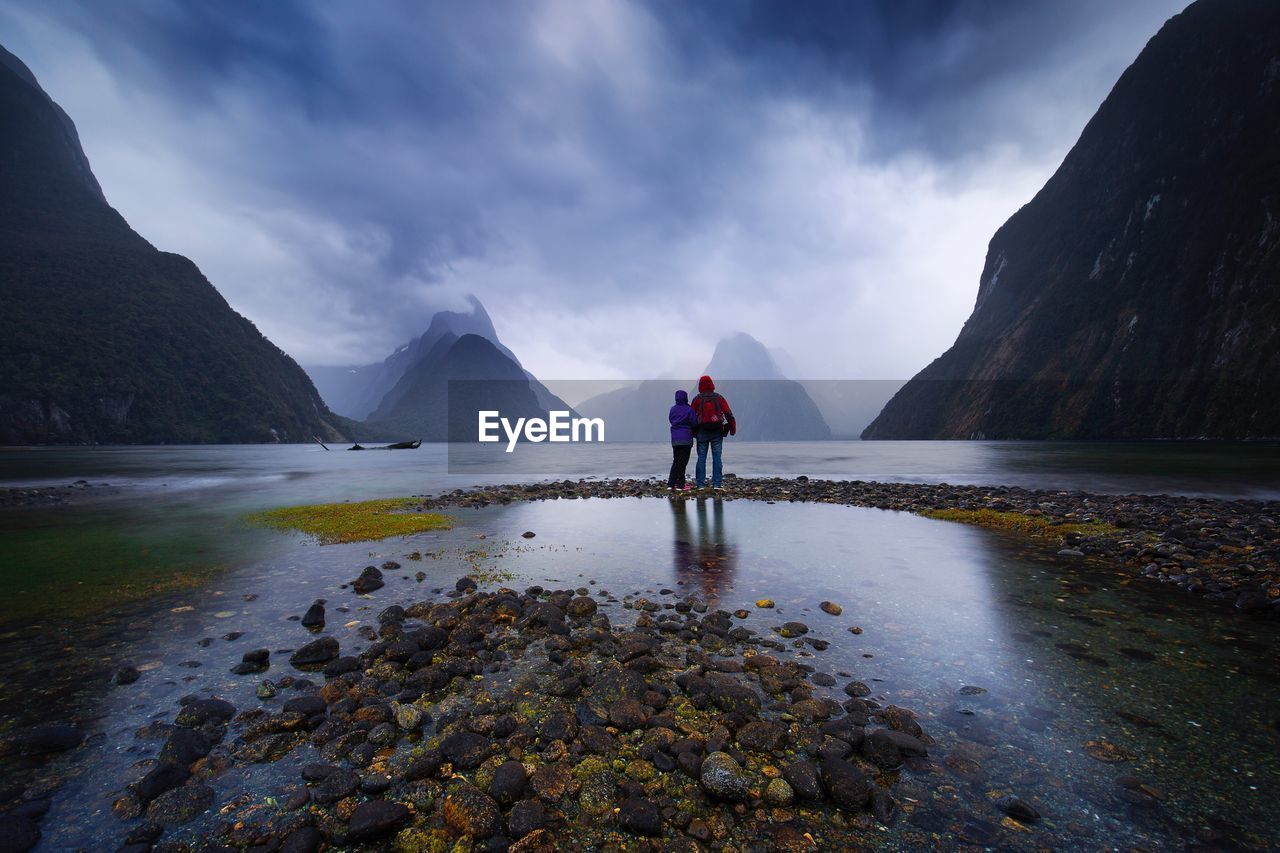 Rear view of people on mountain landscape