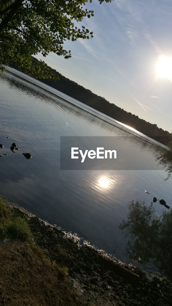 SCENIC VIEW OF LAKE AT SUNSET