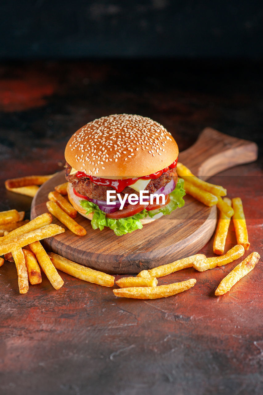 close-up of burger with french fries on table