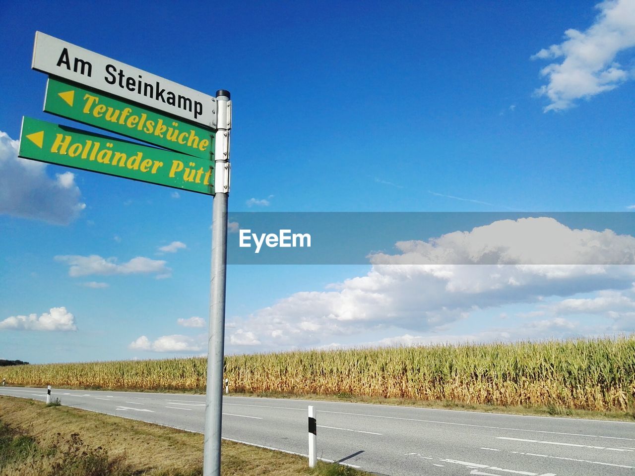 VIEW OF ROAD AGAINST CLOUDY SKY