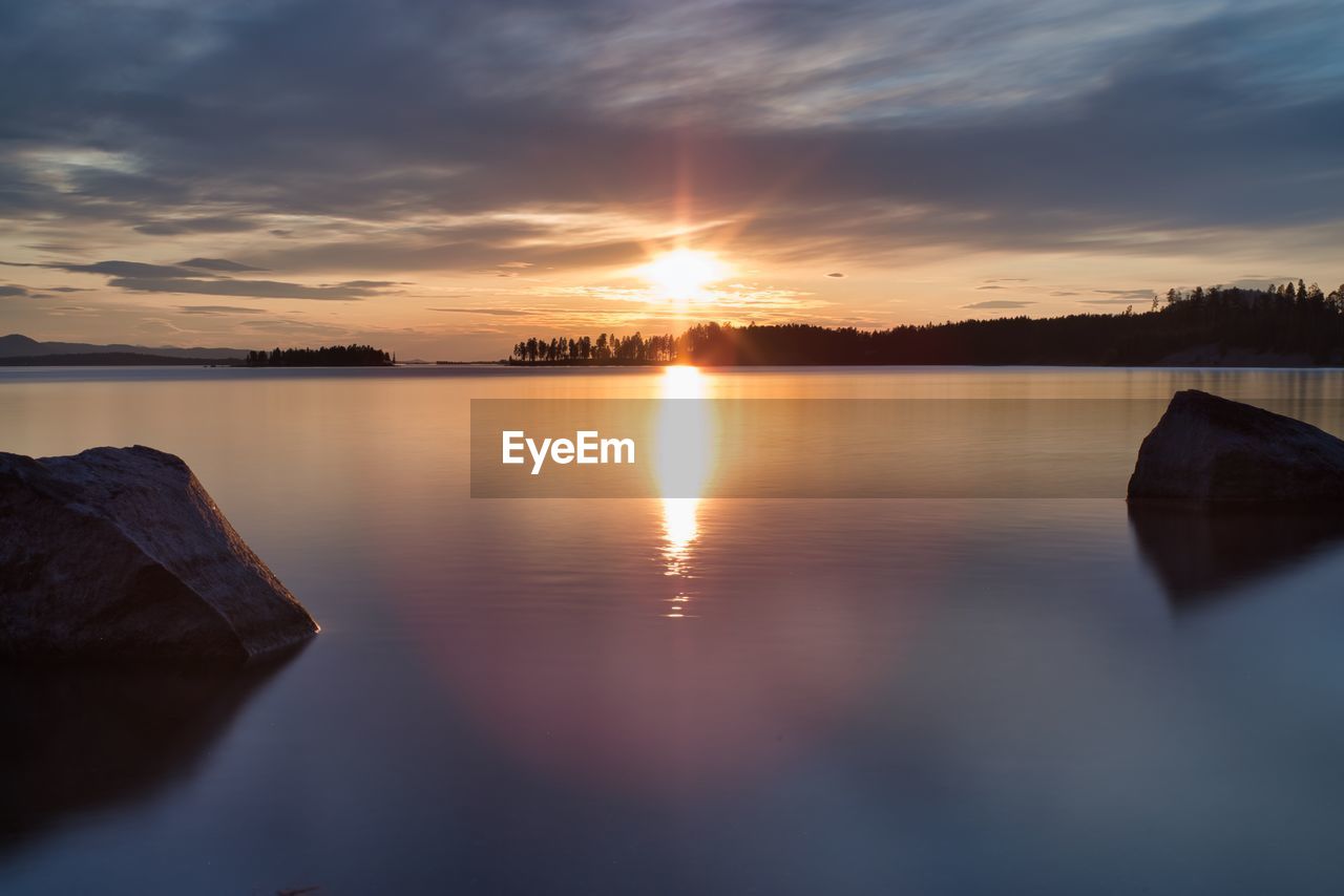 Scenic view of lake against sky during sunset